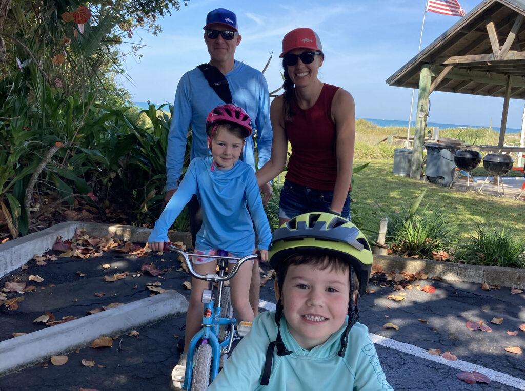 mom with family riding bike