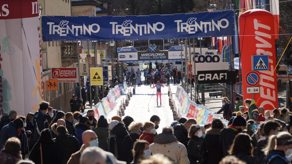 Spectators cheer on finishers at a ski race.