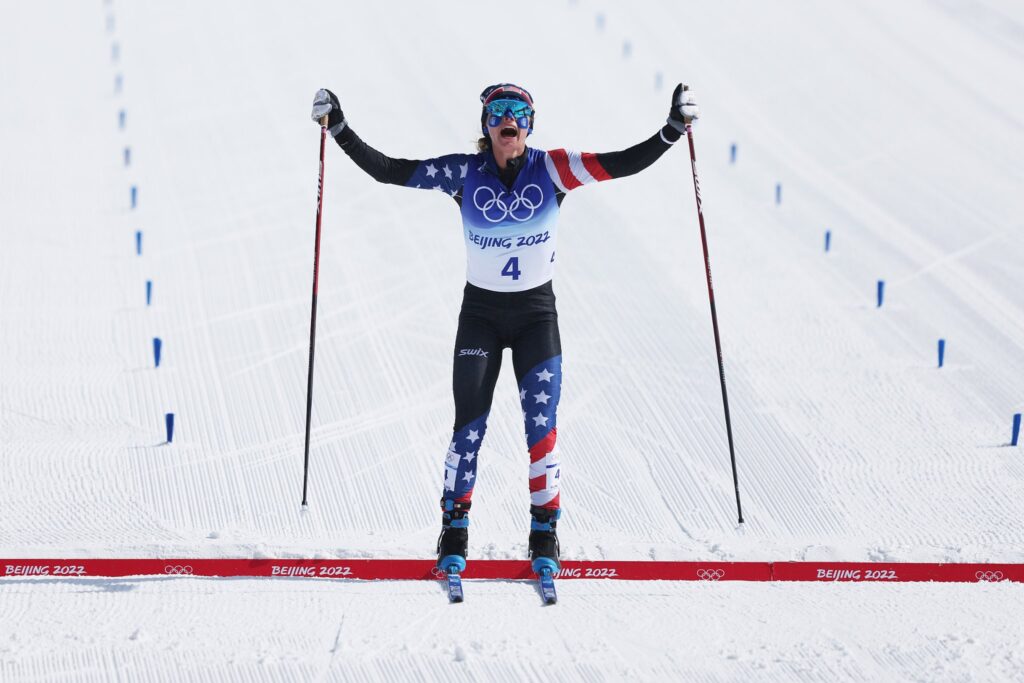 Jessie Diggins crosses the finish line at the Olympics in China.