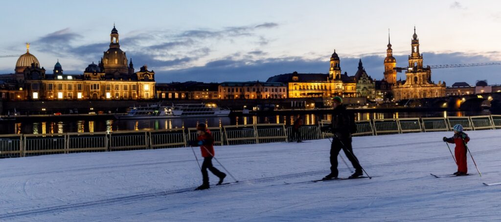 A family heads out for an evening ski after the races